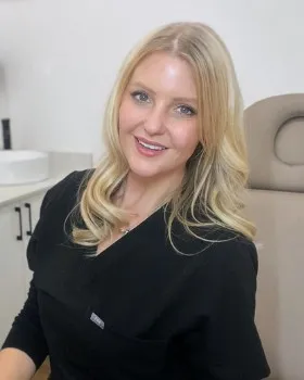 Hayley Ford sitting in her clinic room, smiling